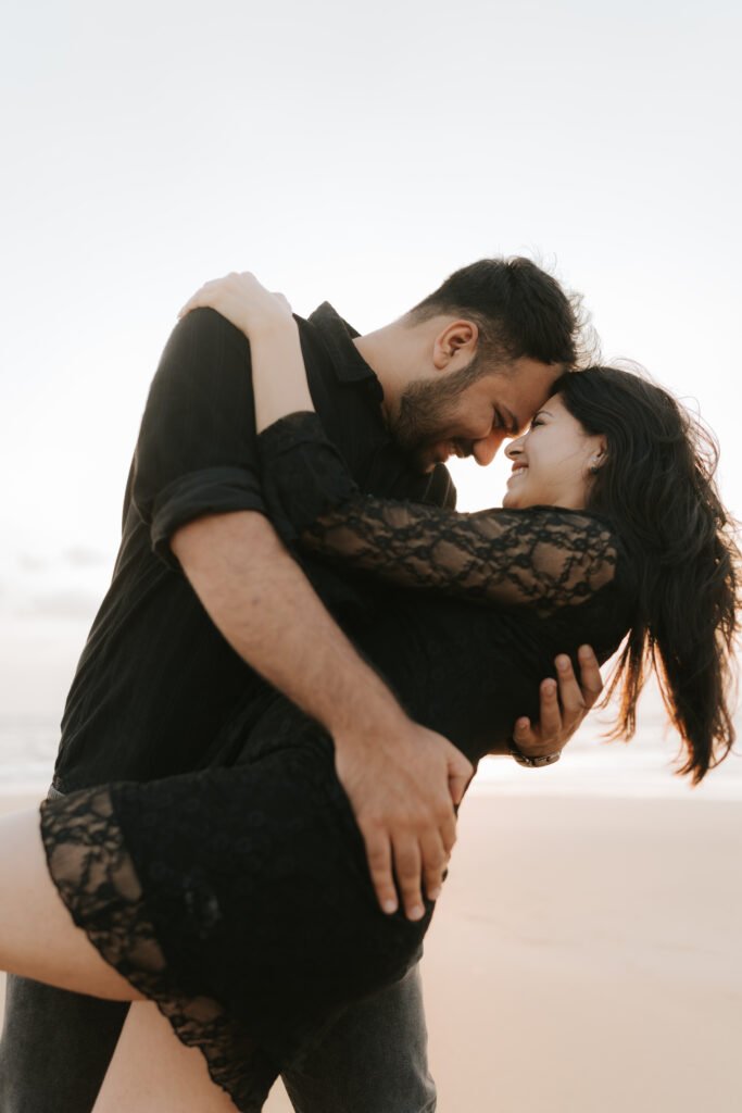 Romantic couple portrait on Diu beach with soft evening light and the Arabian Sea in the background.