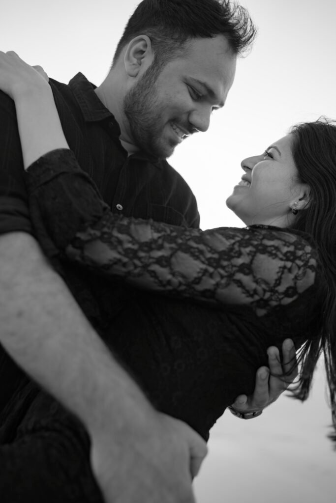 Editorial style couple photography with black outfits on a scenic Diu beach.