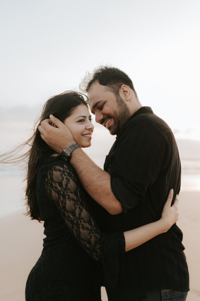 Couple walking hand in hand on a quiet Diu beach during their pre-wedding photoshoot.