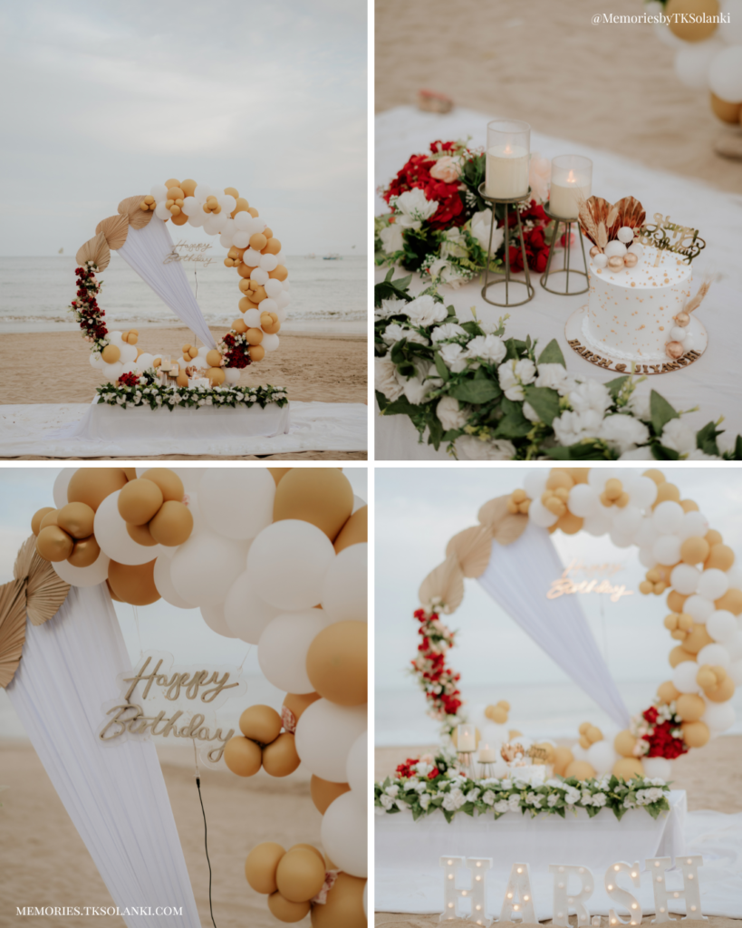 Beach birthday setup in Diu with white and gold balloons, flowers and birthday cake